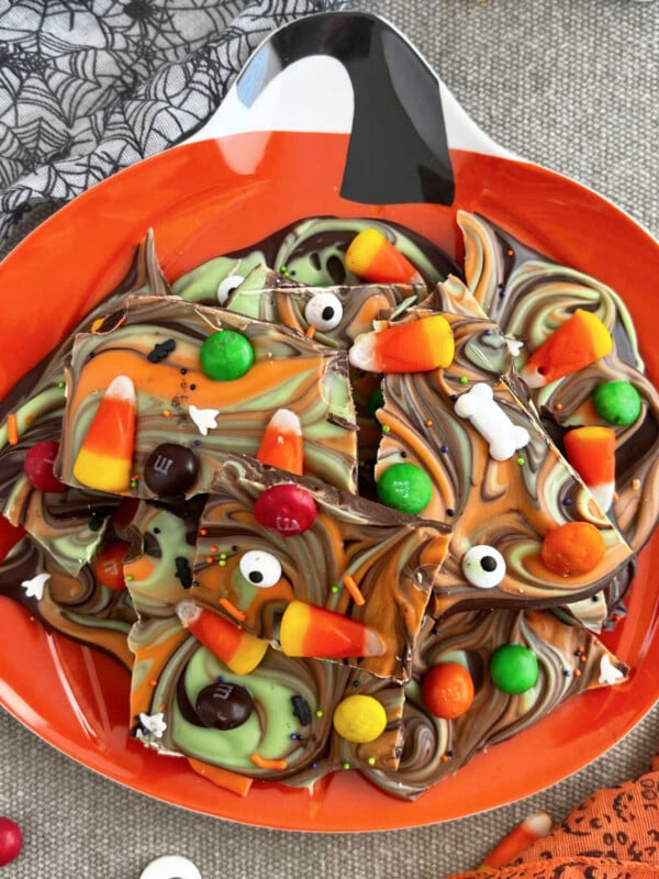 Halloween candy bark with candy corn on a jack o lantern plate.