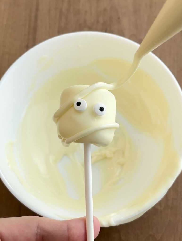 make mummy marshmallow pop with melted white chocolate.