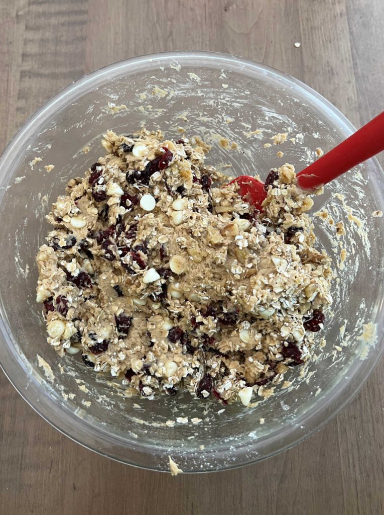 mix oats and craisins in cookie dough with spatula.