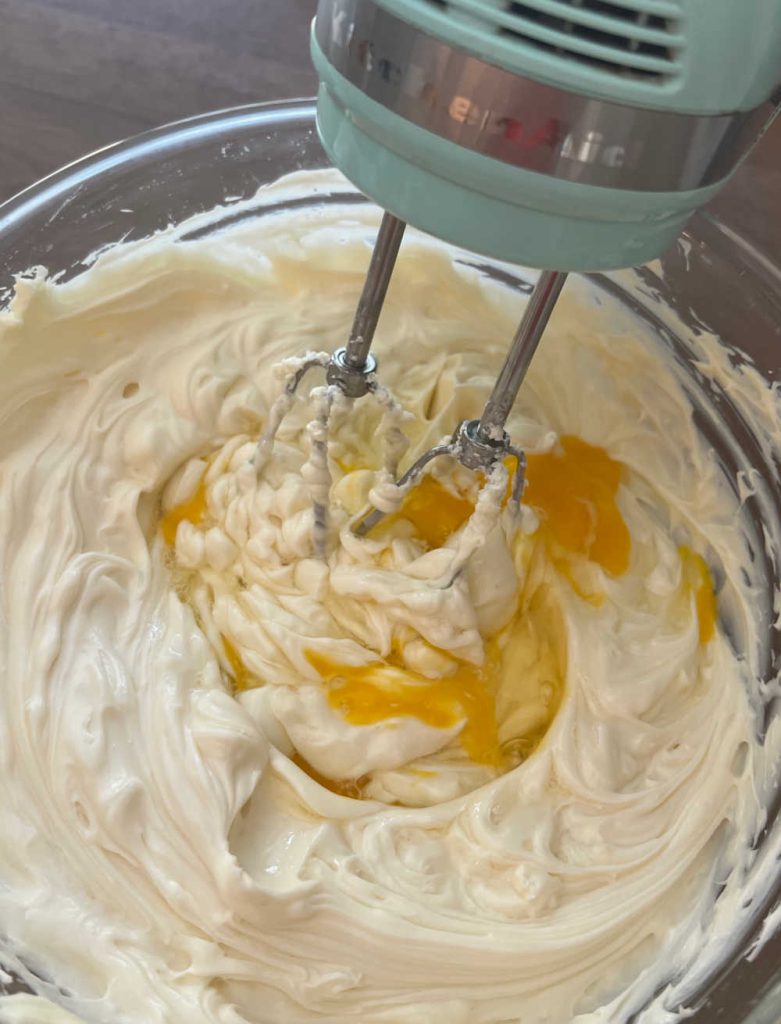 mix cream cheese filling with eggs in mixing bowl.
