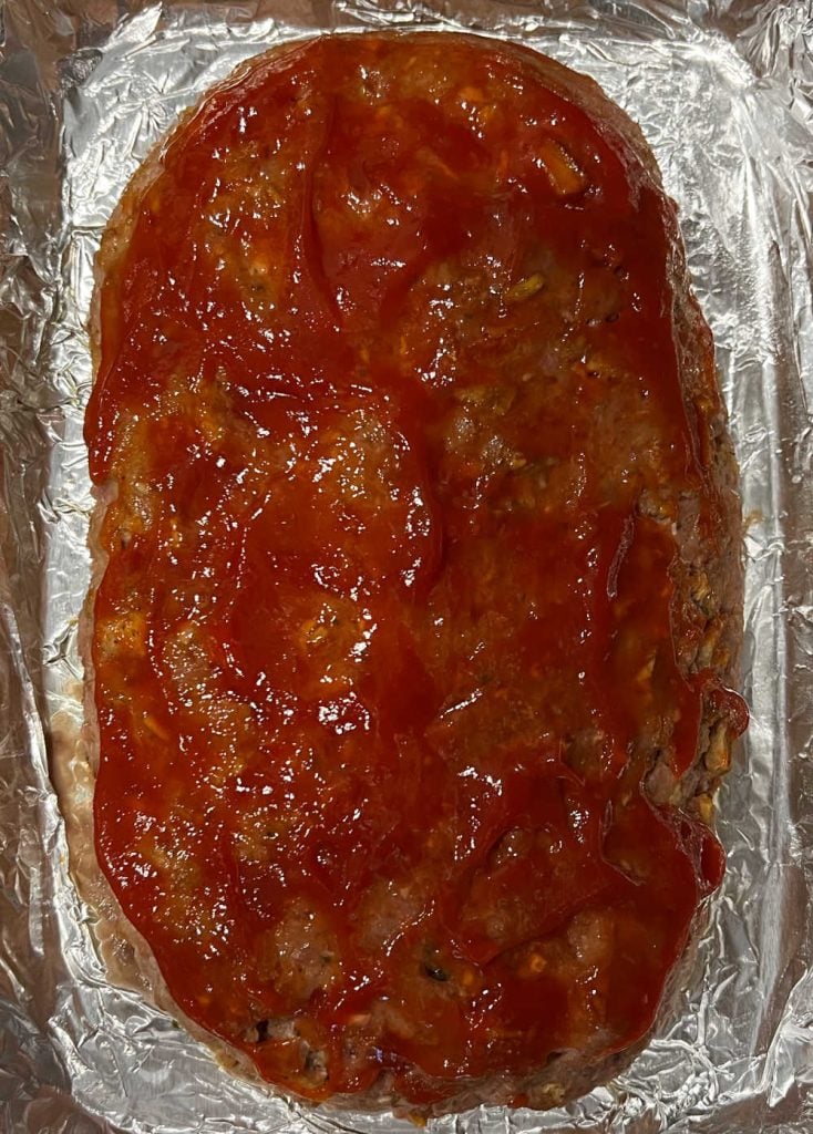 meatloaf with ketchup in baking dish.
