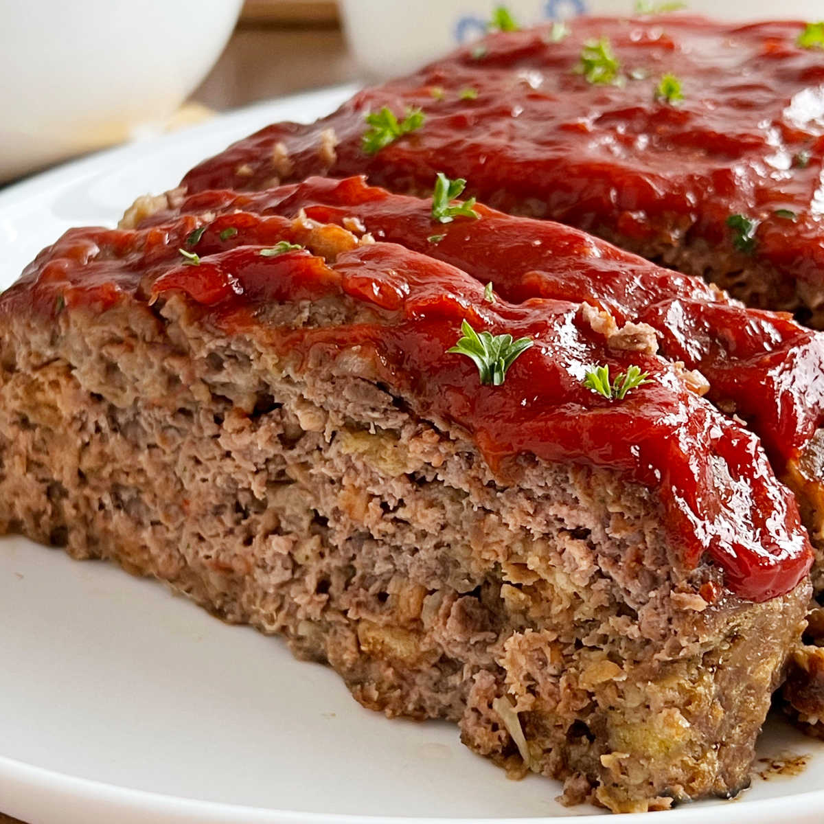 stove top stuffing meatloaf with ketchup glaze sliced on platter.