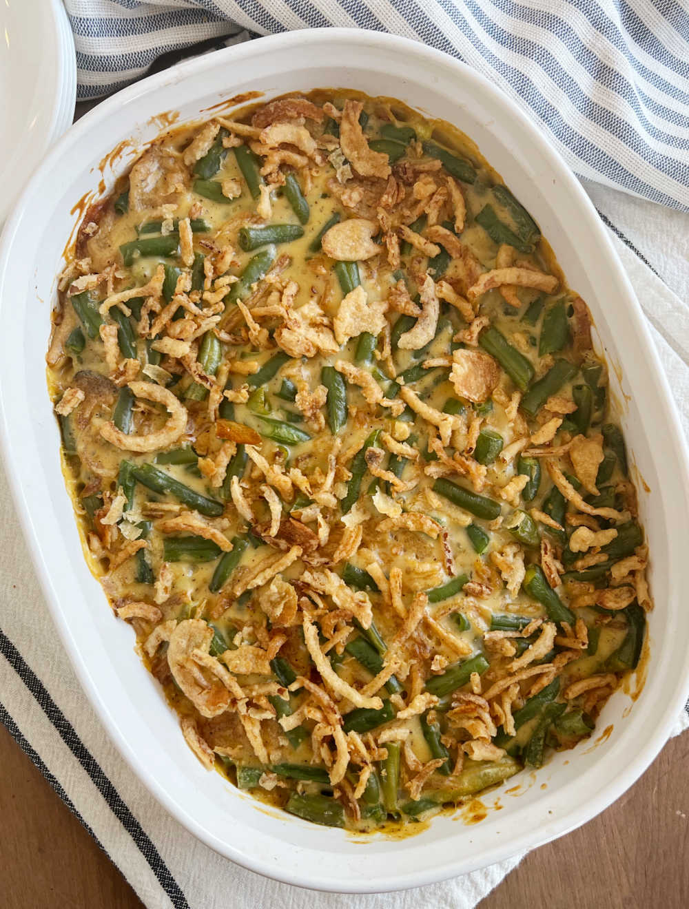 green bean casserole with cream of chicken soup in baking dish on table.