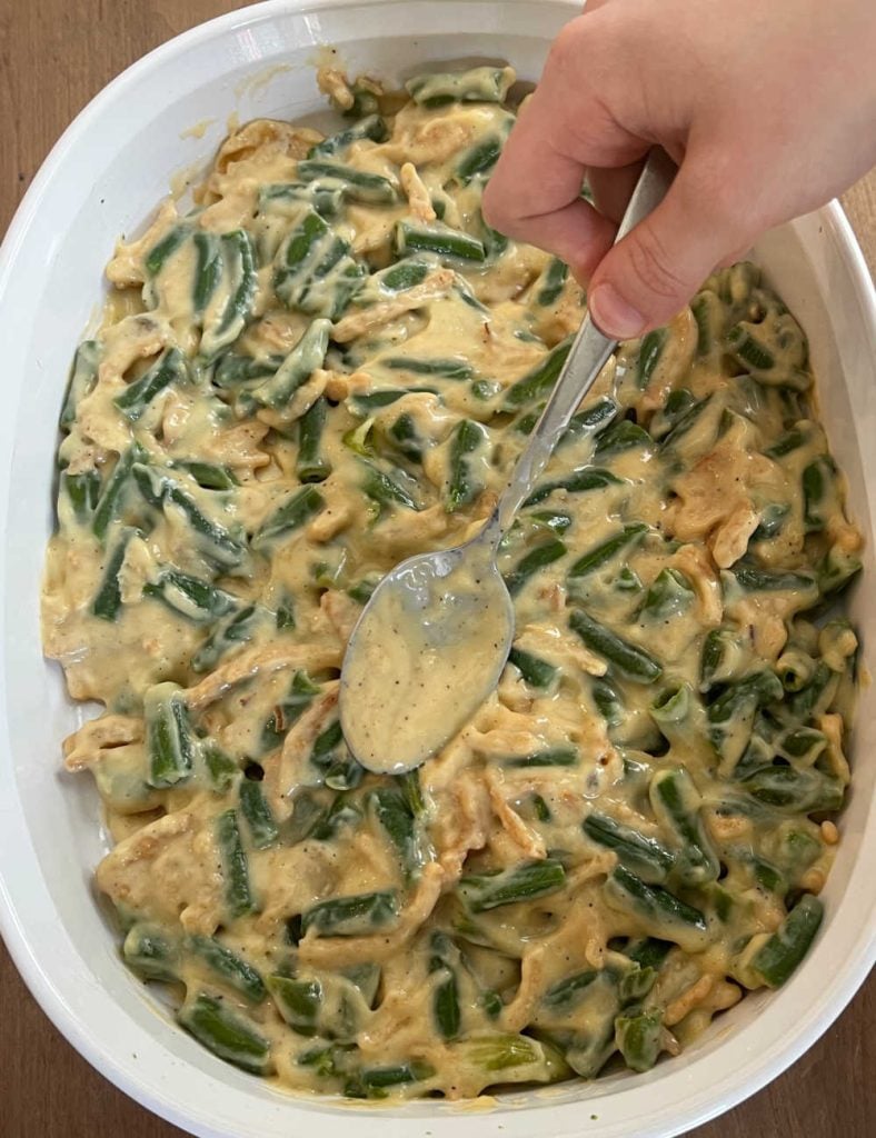 spread ingredients in casserole dish with spoon.