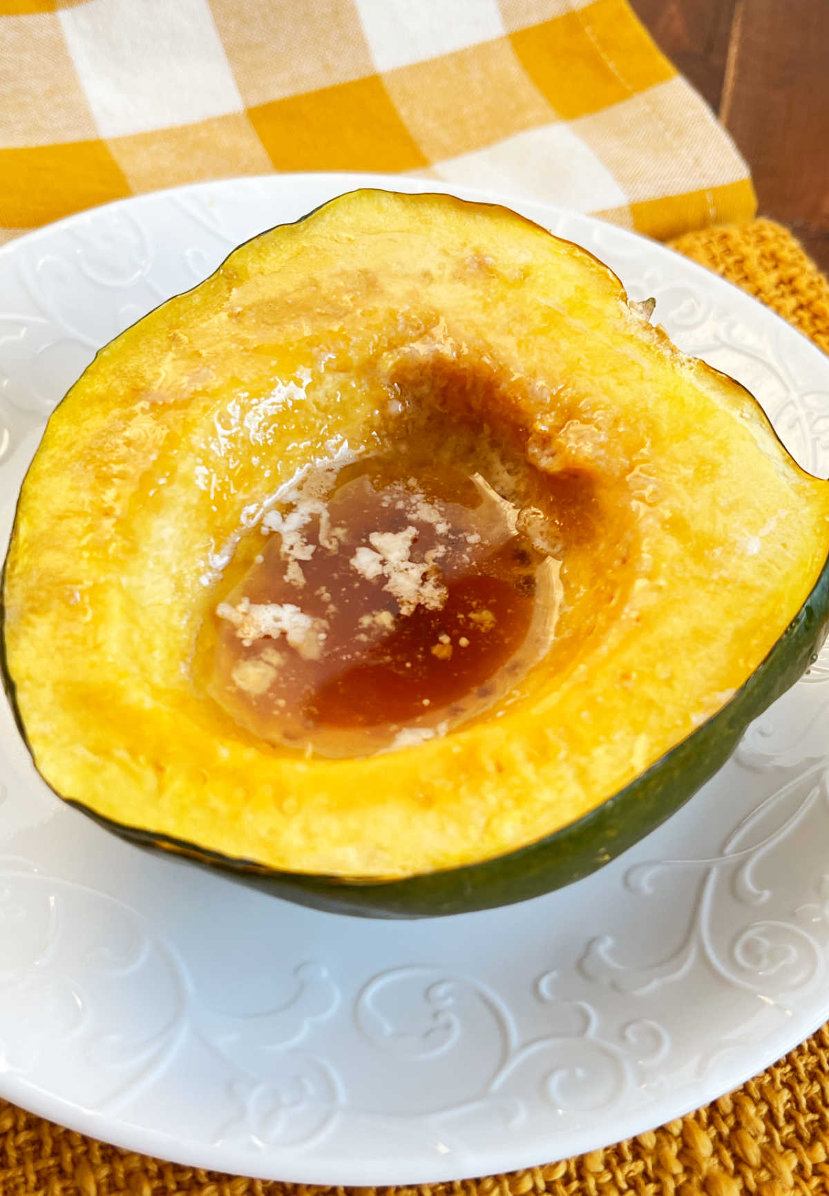 microwaved acorn squash half with melted butter brown sugar center.