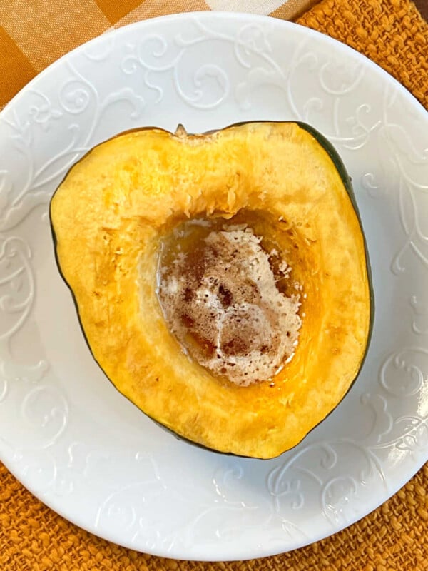 microwave acorn squash with butter and brown sugar on plate.