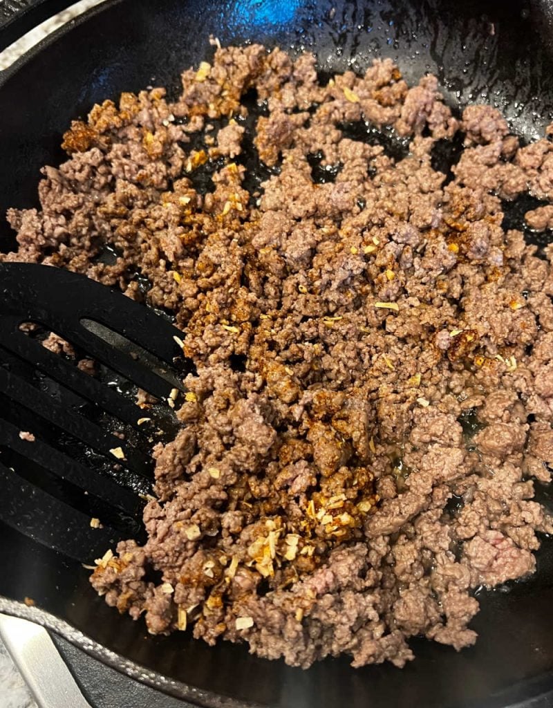 brown ground beef and spices in skillet.