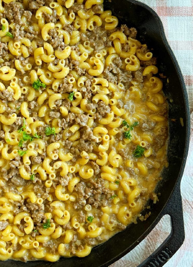homemade cheeseburger macaroni in skillet with parsley.