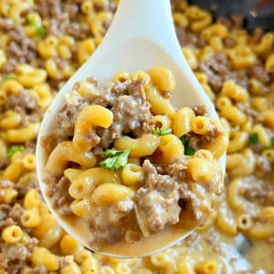 homemade cheeseburger macaroni hamburger helper on a white serving spoon.