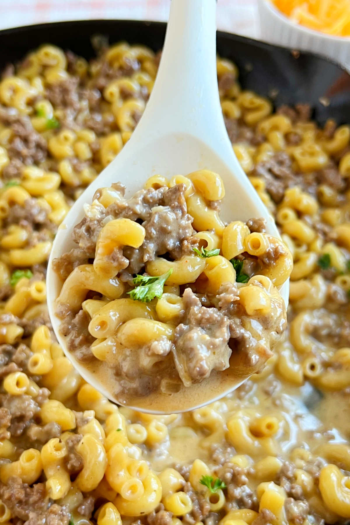 homemade cheeseburger macaroni hamburger helper on a serving spoon.