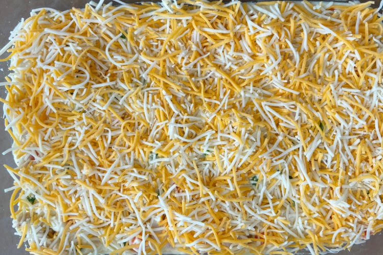 shredded cheddar blend cheese on casserole flling.