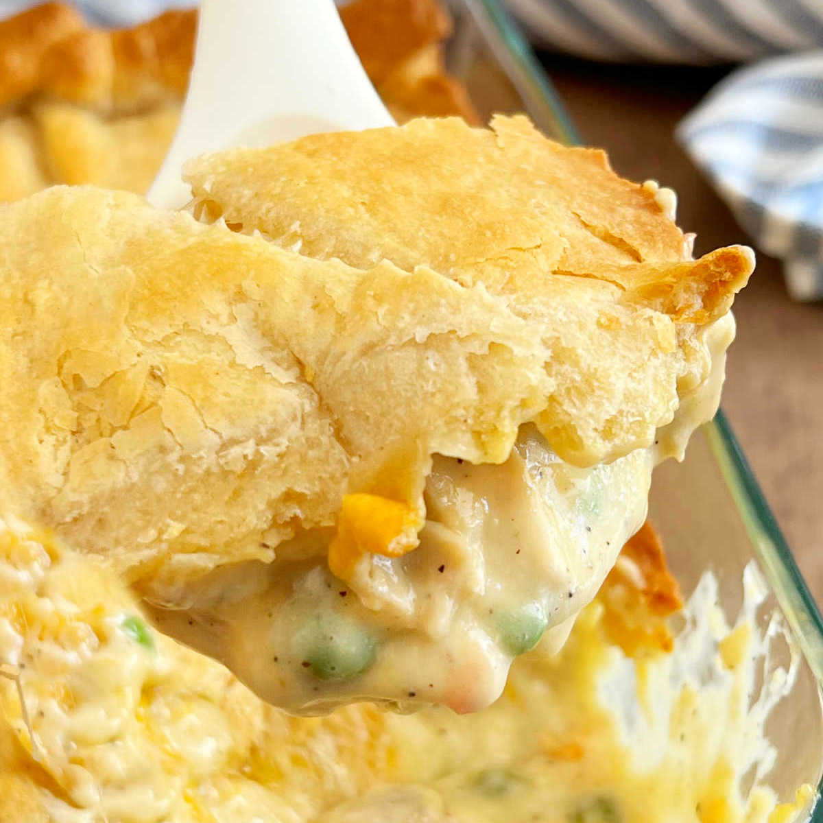 chicken pot pie casserole on a serving spoon.