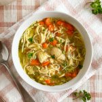 bowl of homemade chicken noodle soup with leftover chicken in homemade stock.
