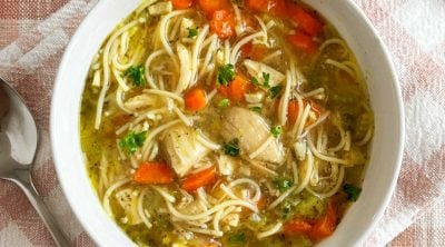 bowl of homemade chicken noodle soup with leftover chicken in homemade stock.