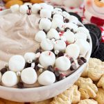 bowl of hot chocolate dip with mini marshmallows and chocolate chips.