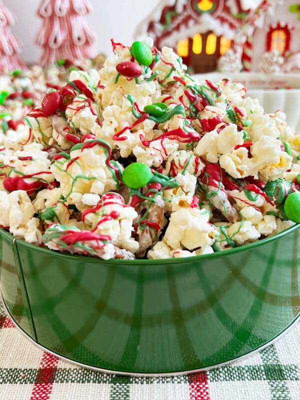 Christmas crunch snack mix with popcorn and pretzels on the table.
