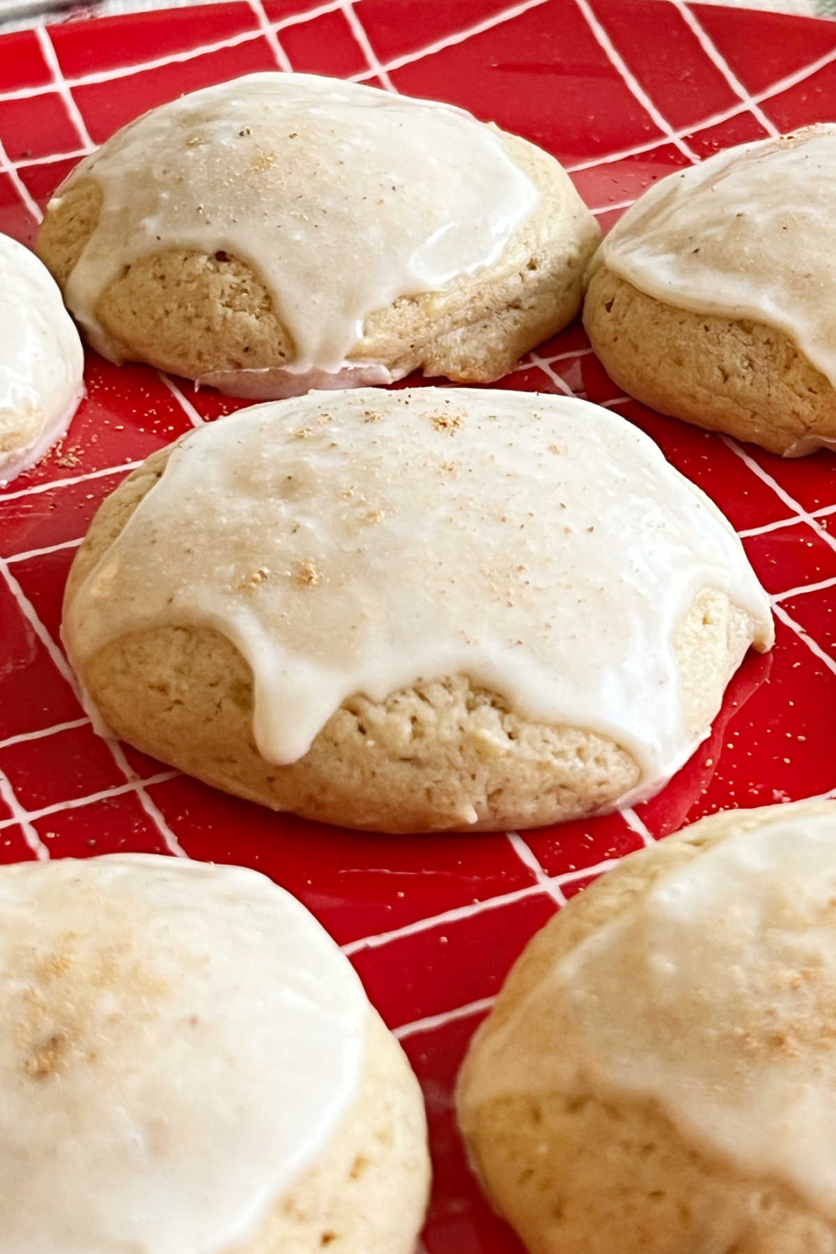eggnog cookies with eggnog glaze on a red plate.