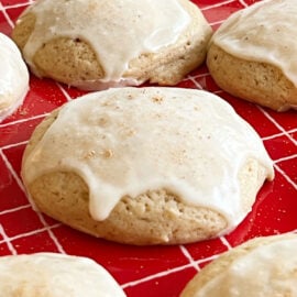 glazed eggnog cookies on a red plate.