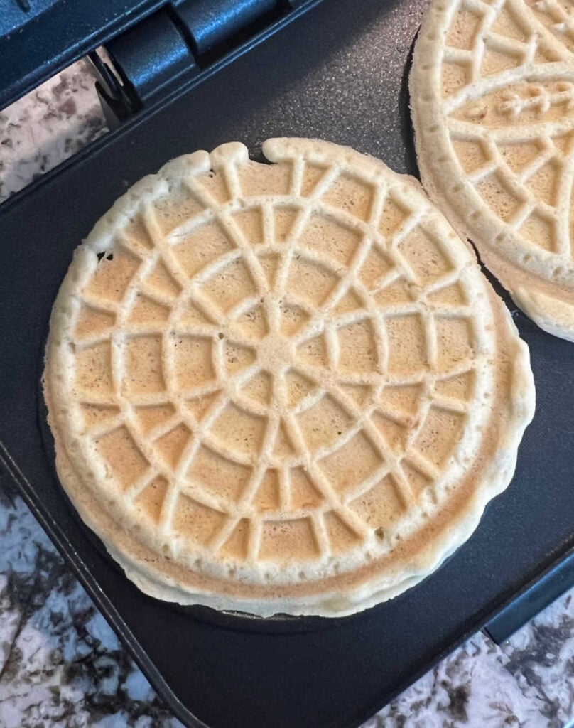 cooked pizzelles on iron.