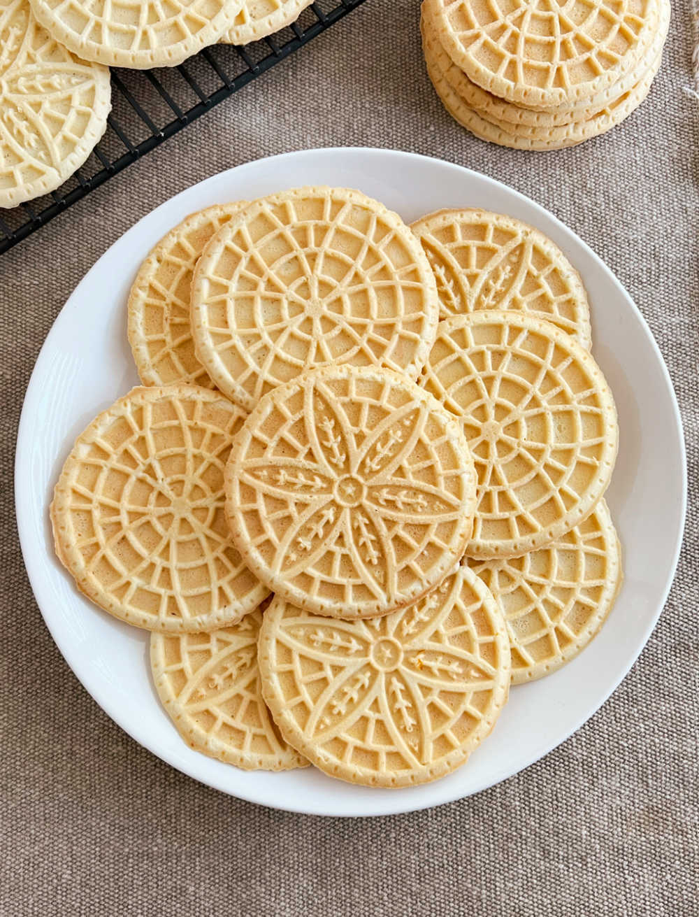 pizzelle cookies on white plate.