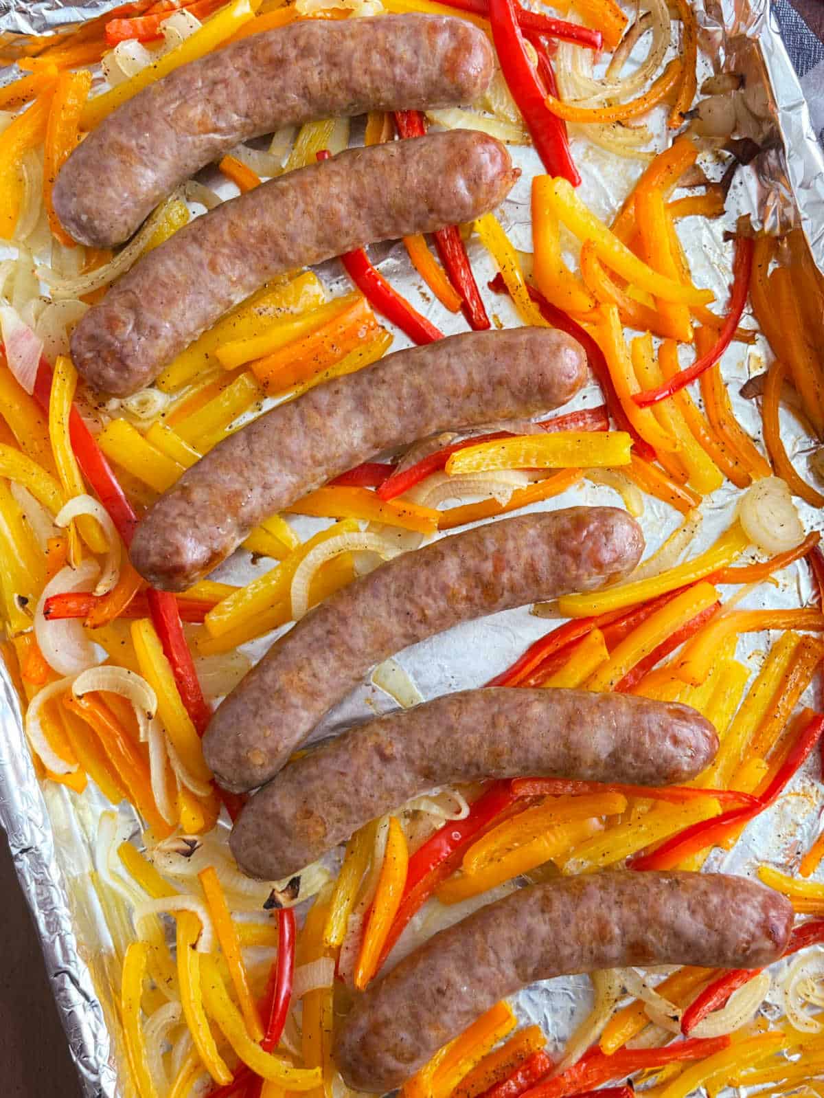 baked sheet pan sausage, peppers and onions.