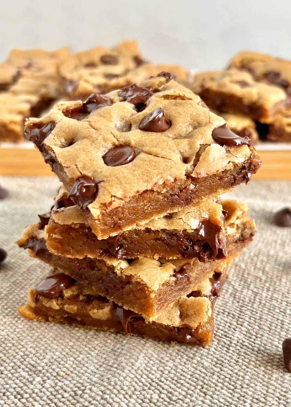 chocolate chip cookie bars stacked on the table.