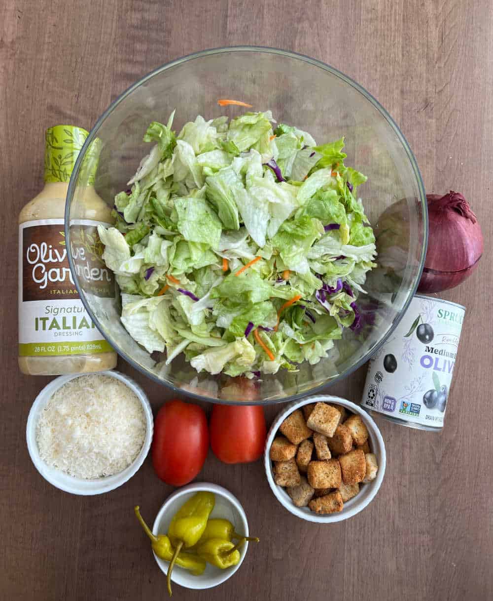 iceberg lettuce, salad dressing, parmesan cheese, peppers, tomatoes, croutons, olives, red onion.