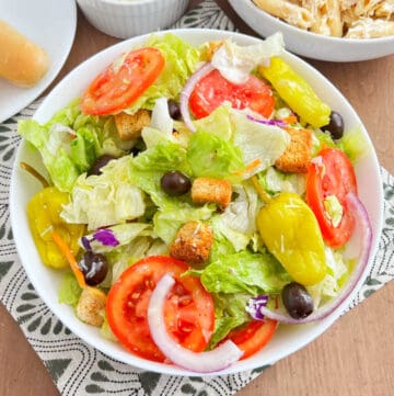 olive garden salad copycat recipe in a serving bowl on the table.