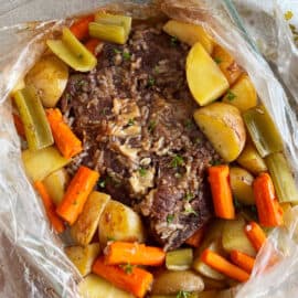 beef pot roast cooked in an oven bag with onion soup mix, carrots, potatoes and celery.