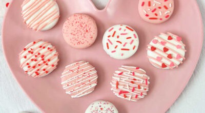 white chocolate dipped oreos covered with valentines day sprinkles.