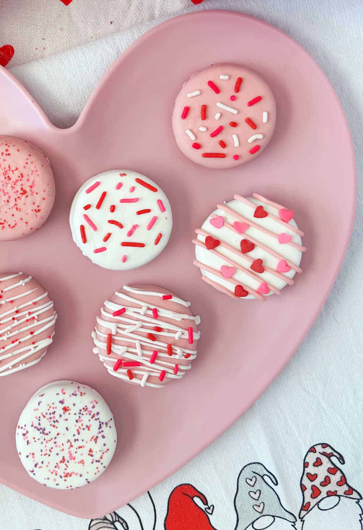white chocolate dipped oreos with Valentines Day sprinkles on gnome towel.