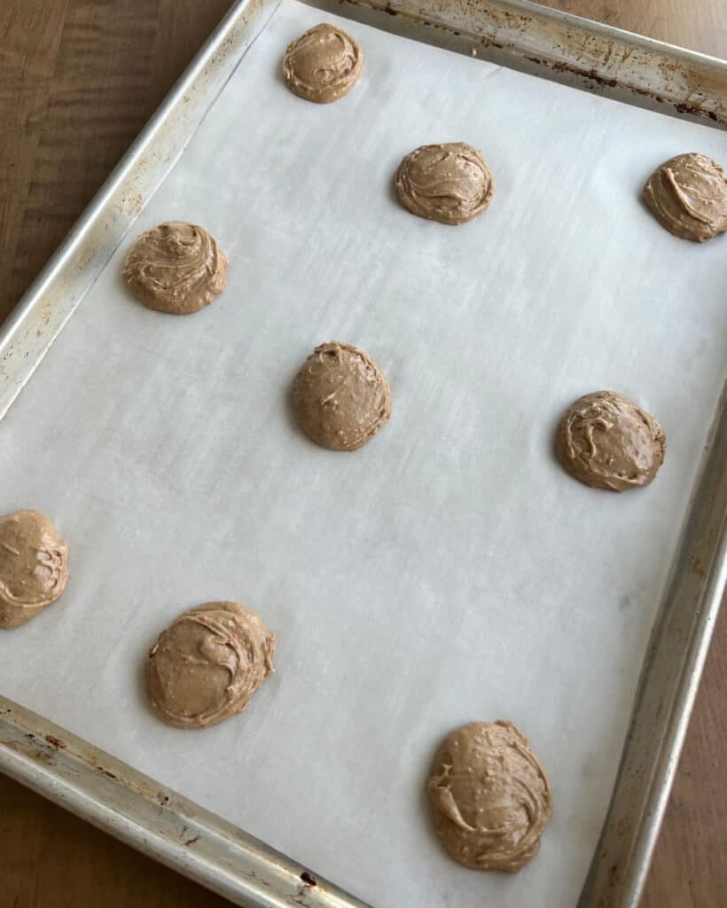 carrot cookie dough balls on baking sheet.