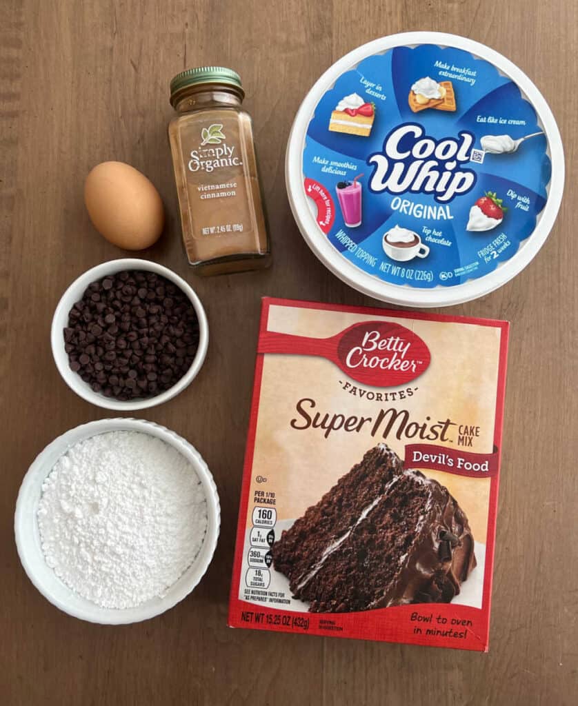 devil's food cake mix, cool whip, cinnamon, egg, chocolate chips, powdered sugar.