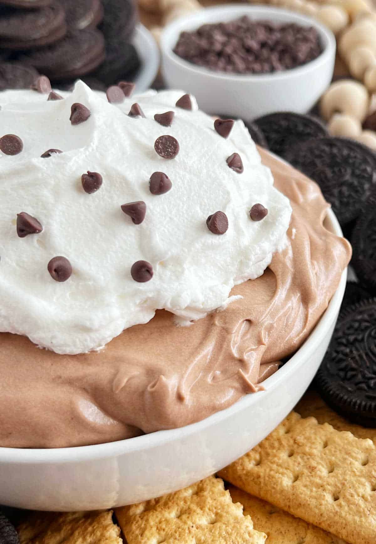 chocolate pudding pie dip recipe with cool whip and chocolate chips in a bowl.