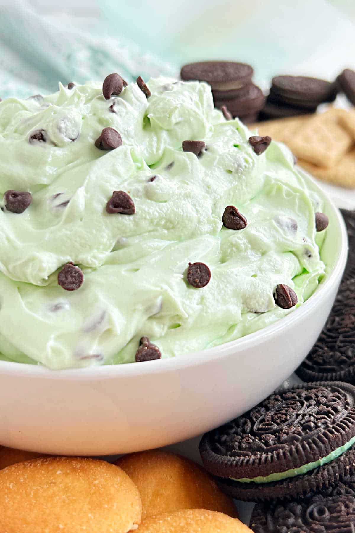 mint chocolate chip dip with mini chocolate chips in white bowl.