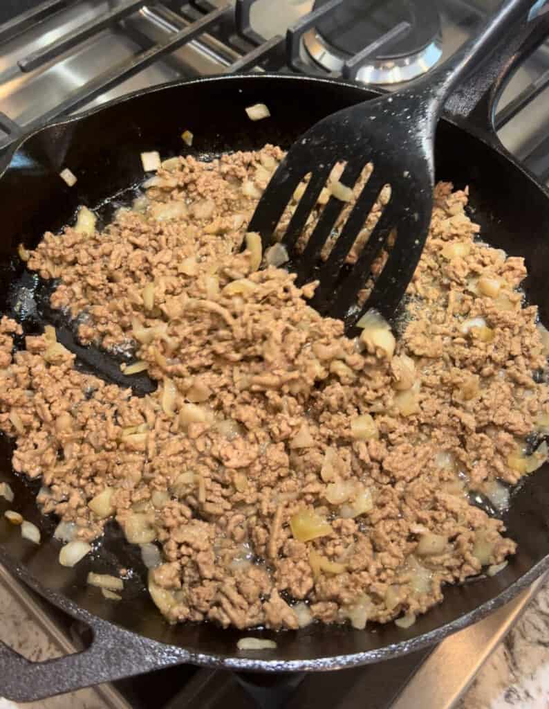 cook ground beef and onion in cast iron skillet.