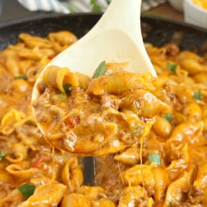 cheesy taco pasta on a serving spoon.