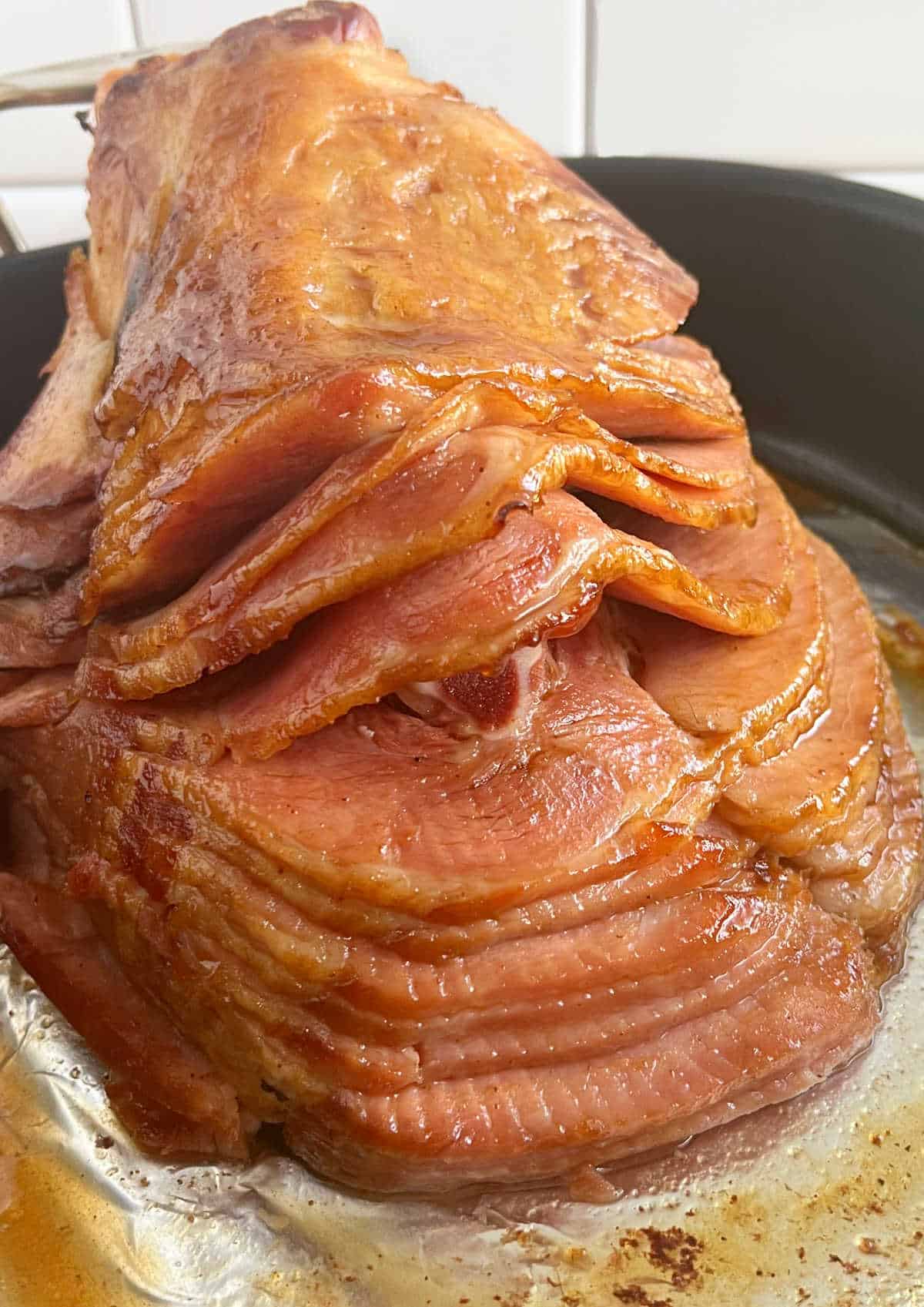 baked Dr Pepper ham in a roasting pan.