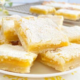 lemon bars with shortbread crust on a plate.