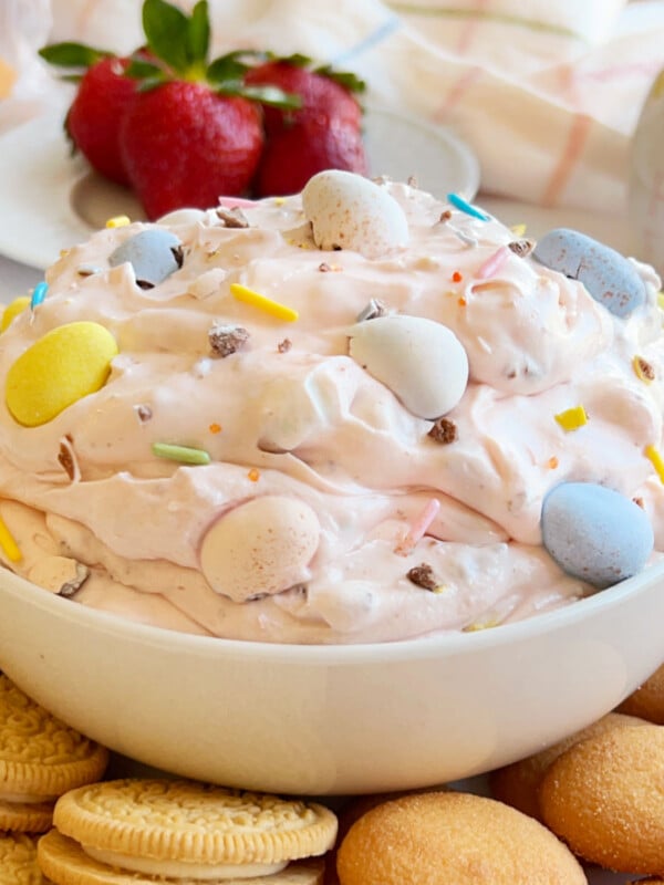 cadbury mini eggs dip in white bowl with dippers.