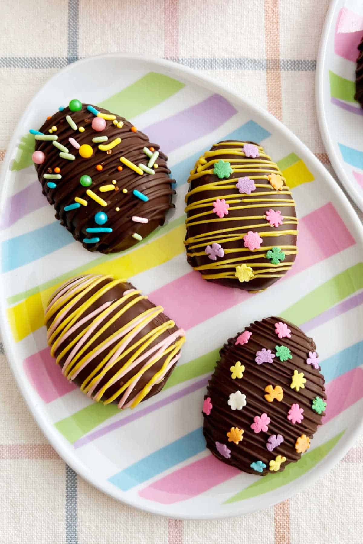 chocolate coated peanut butter eggs on an Easter egg plate.