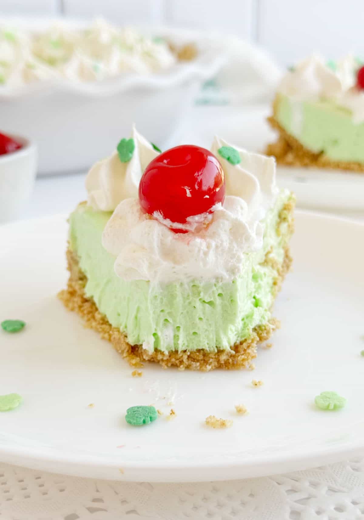 shamrock pie with cherry on top on plate.