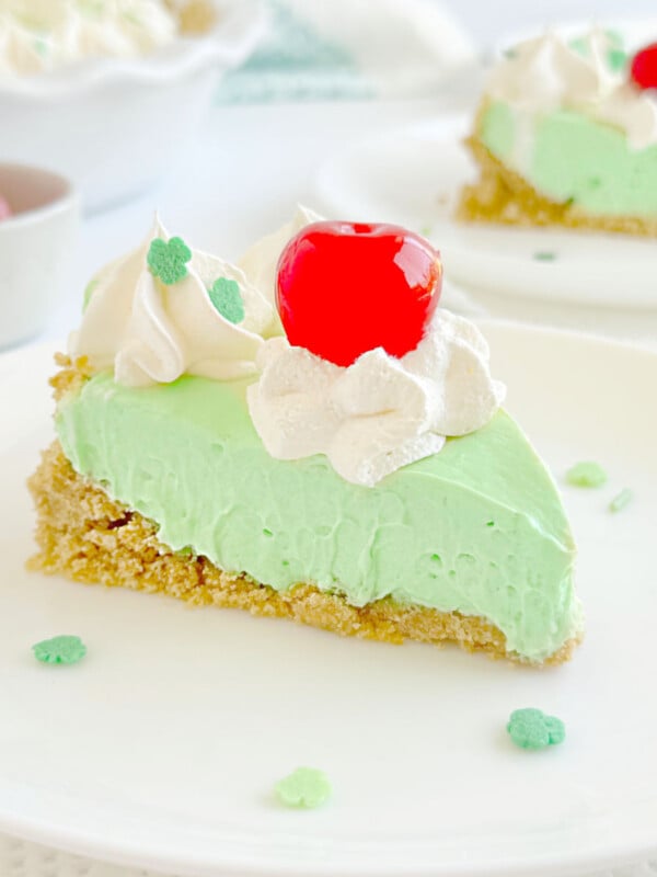 slice of shamrock pie with whipped cream and cherry on top.