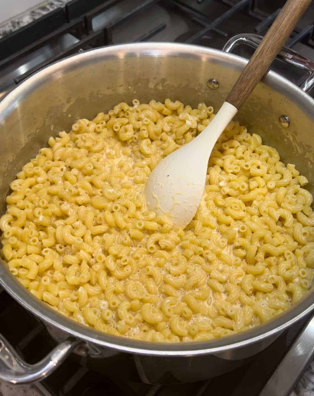 macaroni in creamy sauce on stove.