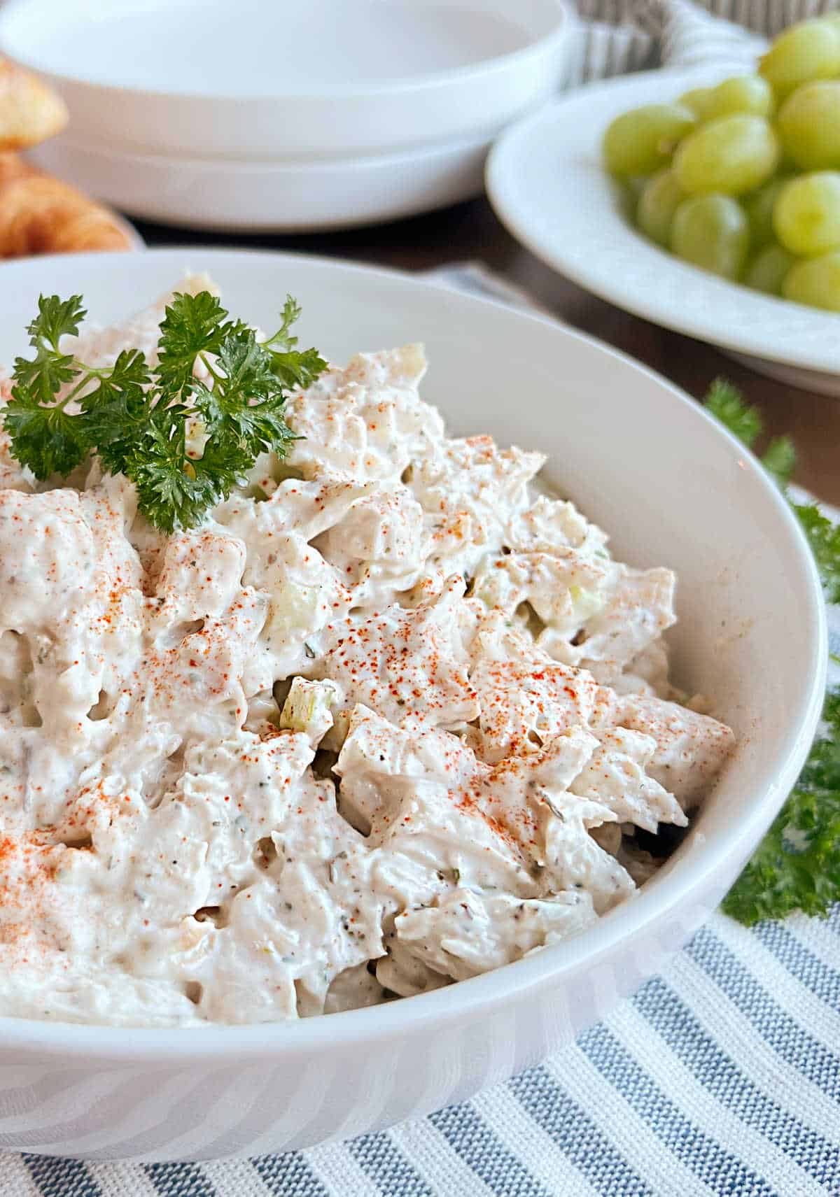 easy chicken salad in bowl with parsley on top.