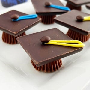 chocolate graduation caps treats made with Reese's candy on a platter.