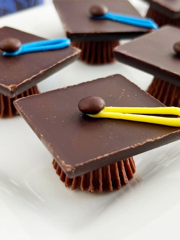 chocolate graduation caps treats made with Reese's candy on a platter.