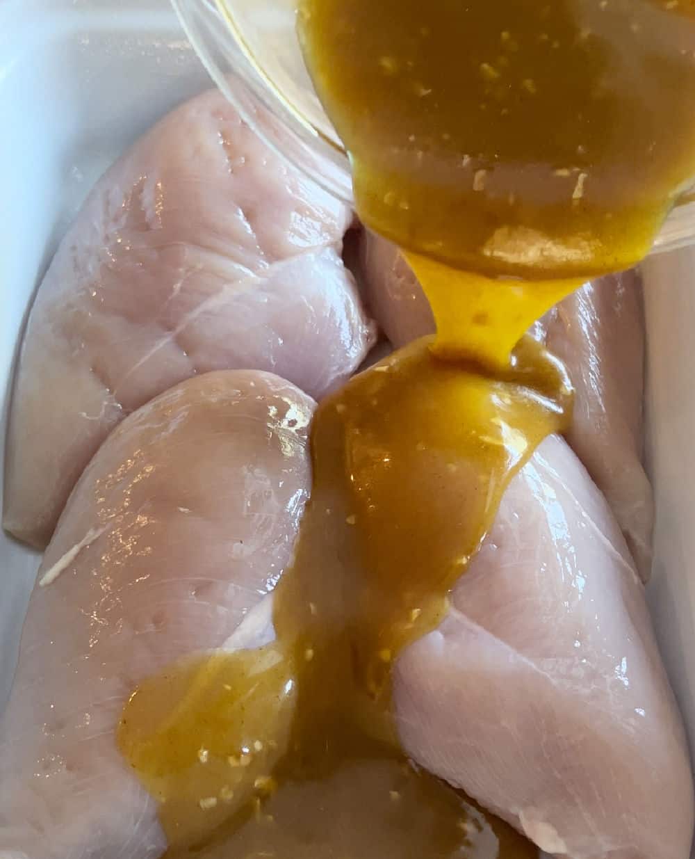 pour sauce over chicken in baking dish.