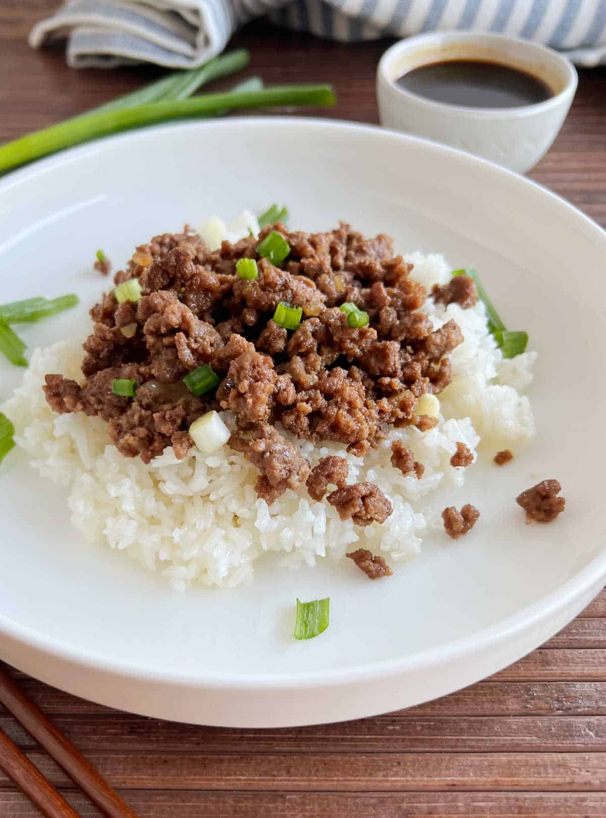 Plate of Korean ground beef over rice on the table.