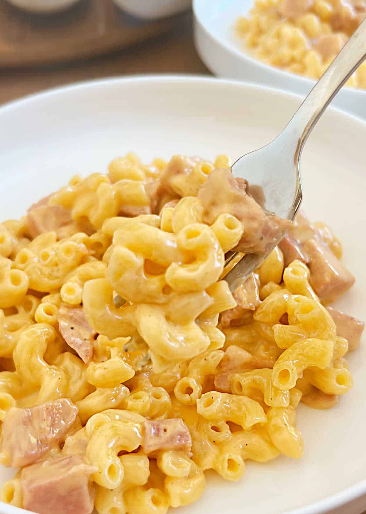 ham mac and cheese on fork.